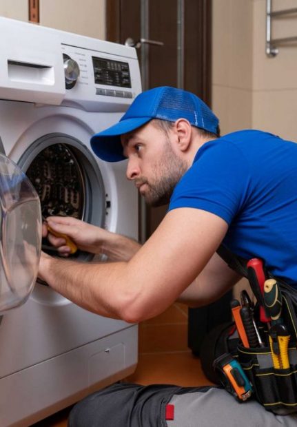 a technician repairing a washer and dryer repair raleigh